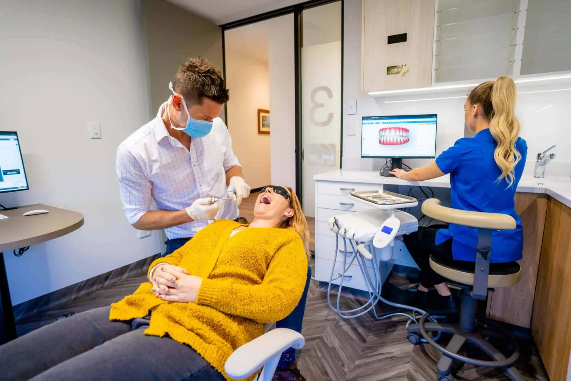 Orthodontist and dental assistant treating a patient in the chair at Central Coast Orthodontics